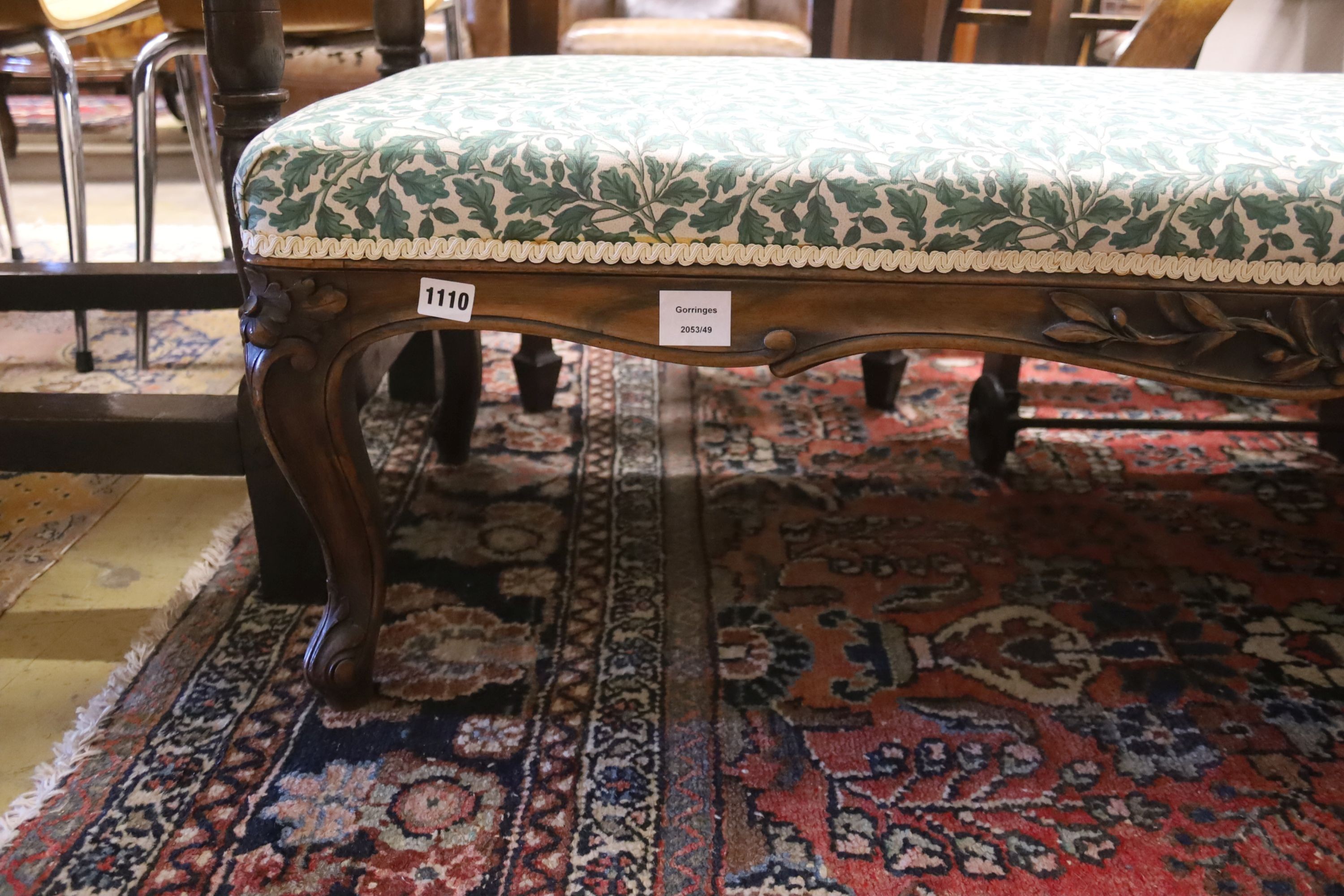 A late 19th century carved walnut upholstered window seat, length 136cm, depth 48cm, height 38cm